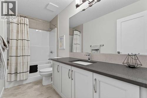 Second floor 4-piece bathroom with quartz countertops and ample storage - 307 Precedence Hill, Cochrane, AB - Indoor Photo Showing Bathroom