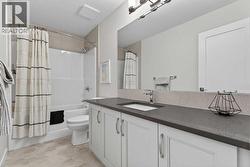 Second floor 4-piece bathroom with quartz countertops and ample storage - 