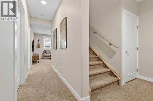 Basement hallway with access to main recreation room - 307 Precedence Hill, Cochrane, AB - Indoor Photo Showing Other Room