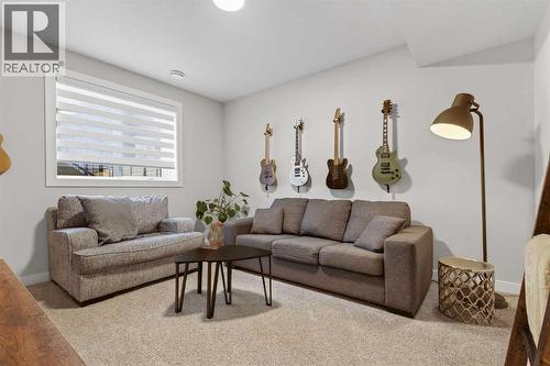 Large and spacious recreation room with large window - 307 Precedence Hill, Cochrane, AB - Indoor Photo Showing Living Room