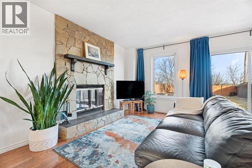 living room with wood burning fireplace - 164 Beddington Circle Ne, Calgary, AB - Indoor Photo Showing Living Room With Fireplace
