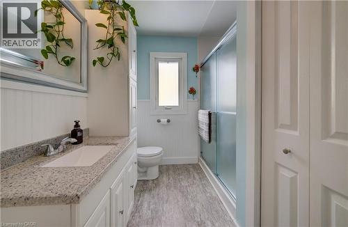Full bath featuring wainscoting, vanity, a stall shower, and light wood-type flooring - 1170 Union Street, Kitchener, ON - Indoor Photo Showing Bathroom