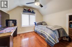 Bedroom with light wood-type flooring and a ceiling fan - 