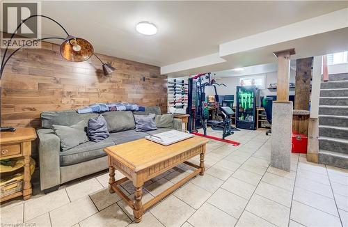 Living area with wood walls and light tile patterned floors - 1170 Union Street, Kitchener, ON - Indoor