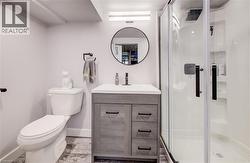 Full bathroom featuring a shower stall and vanity - 