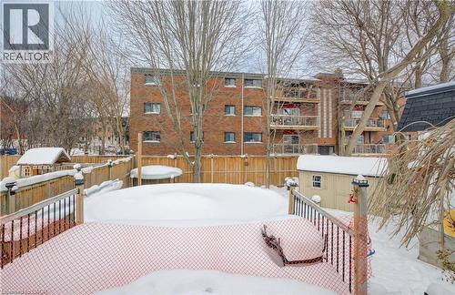 Snow covered deck featuring a storage unit and a fenced backyard - 1170 Union Street, Kitchener, ON - Outdoor