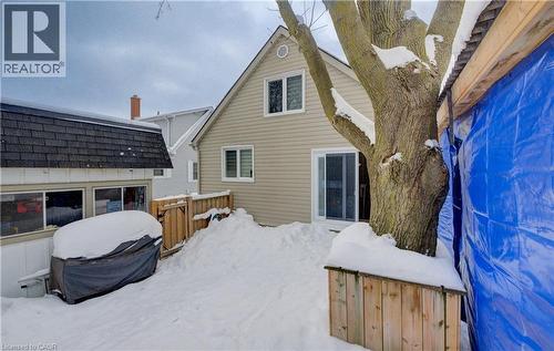 Snow covered house featuring a shingled roof - 1170 Union Street, Kitchener, ON - Outdoor With Exterior