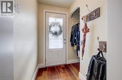 Doorway with baseboards and hardwood / wood-style floors - 