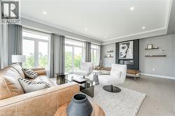 Living room with ornamental molding and recessed lighting - 