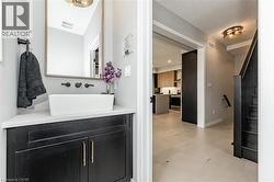 Bathroom featuring vanity, light flooring, and a textured ceiling - 