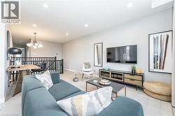 Living room with a chandelier and recessed lighting - 