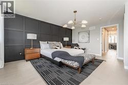 Bedroom with a decorative wall, a chandelier, and an accent wall - 