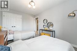 Carpeted bedroom featuring a closet and baseboards - 