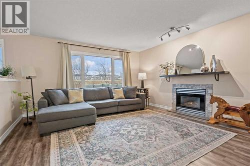 43 Sunset Crescent, Okotoks, AB - Indoor Photo Showing Living Room With Fireplace
