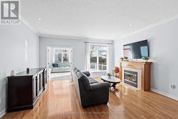 Living room includes gas fireplace w wooden mantle - 