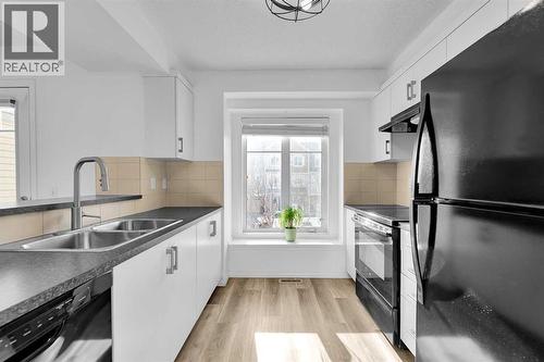 bright kitchen - 169 Windstone Park Sw, Airdrie, AB - Indoor Photo Showing Kitchen With Double Sink