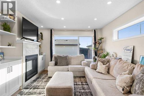17 Cranford Place Se, Calgary, AB - Indoor Photo Showing Living Room With Fireplace