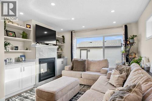 17 Cranford Place Se, Calgary, AB - Indoor Photo Showing Living Room With Fireplace