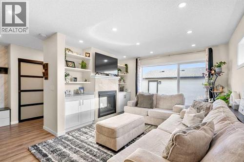 17 Cranford Place Se, Calgary, AB - Indoor Photo Showing Living Room With Fireplace
