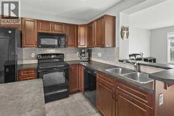 Kitchen with Sink looking out onto the sunny front street - 