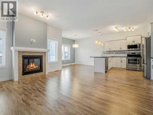 98 Moonlight Boulevard W, Lethbridge, AB - Indoor With Fireplace