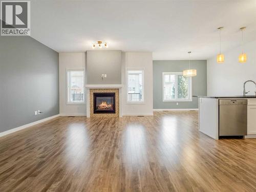 98 Moonlight Boulevard W, Lethbridge, AB - Indoor Photo Showing Living Room With Fireplace