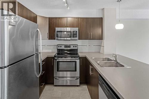 304, 2300 Evanston Square Nw, Calgary, AB - Indoor Photo Showing Kitchen With Double Sink