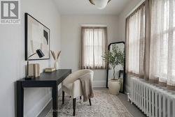 Staged with AI. Main floor office/den - 