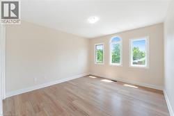 Empty room with light wood finished floors and baseboards - 