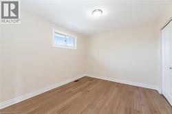 Unfurnished bedroom with light wood finished floors and a closet - 