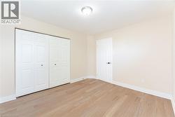 Unfurnished bedroom featuring light wood-style flooring and a closet - 