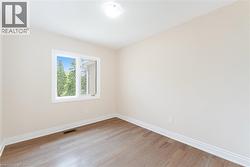 Empty room featuring light wood-style floors - 