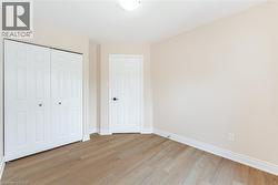 Unfurnished bedroom with light wood-type flooring and a closet - 