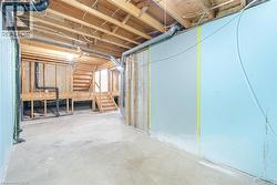 Unfinished below grade area featuring stairway - 