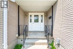 Property entrance featuring brick siding and a porch - 