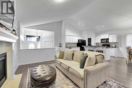 65 Sunset Heights, Cochrane, AB - Indoor Photo Showing Living Room With Fireplace