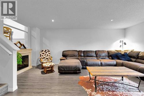 65 Sunset Heights, Cochrane, AB - Indoor With Fireplace