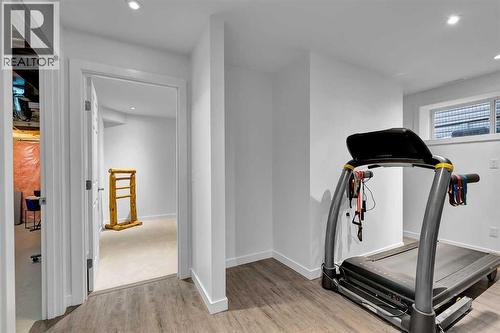 65 Sunset Heights, Cochrane, AB - Indoor Photo Showing Gym Room