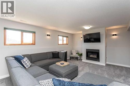 34 Bruns Bay, Lacombe, AB - Indoor Photo Showing Living Room With Fireplace