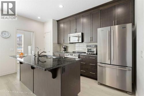 167 Fireside Drive, Cochrane, AB - Indoor Photo Showing Kitchen With Stainless Steel Kitchen With Upgraded Kitchen