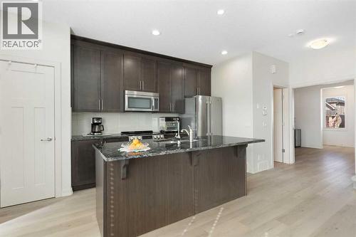 167 Fireside Drive, Cochrane, AB - Indoor Photo Showing Kitchen With Stainless Steel Kitchen With Upgraded Kitchen