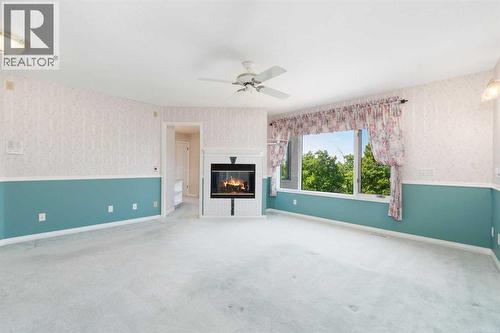 1600 Evergreen Hill Sw, Calgary, AB - Indoor Photo Showing Other Room With Fireplace