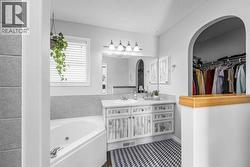 Ensuite with jetted corner tub and walk-in closet - 