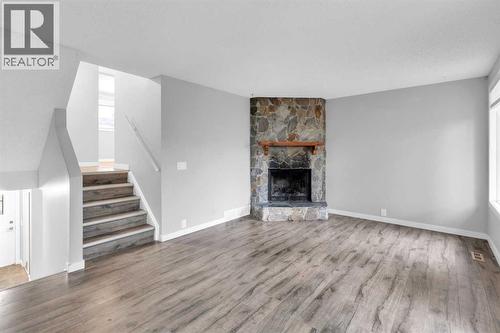 1418 Ranchlands Road Nw, Calgary, AB - Indoor Photo Showing Living Room With Fireplace