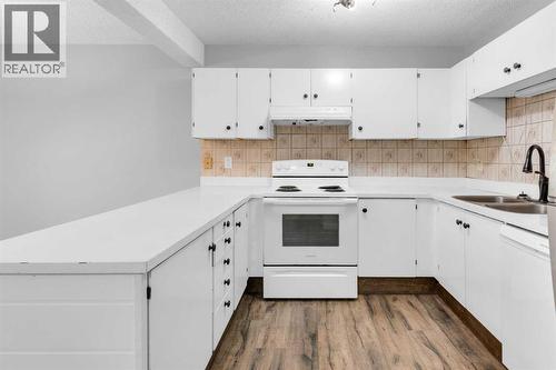 1418 Ranchlands Road Nw, Calgary, AB - Indoor Photo Showing Kitchen With Double Sink