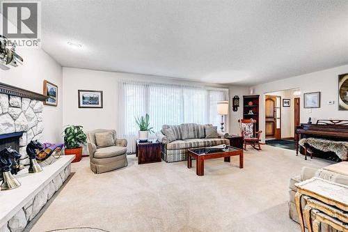 1111 Beverley Boulevard Sw, Calgary, AB - Indoor Photo Showing Living Room With Fireplace