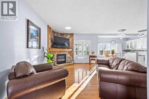 244 Oakmere Place, Chestermere, AB - Indoor Photo Showing Living Room With Fireplace