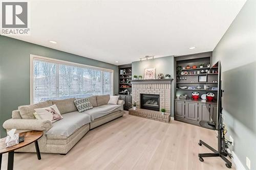 668 Scimitar Bay Nw, Calgary, AB - Indoor Photo Showing Living Room With Fireplace