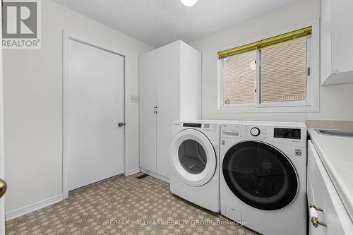 Laundry room with appliances and garage door - 944 Greenbriar Avenue, Ottawa, ON - Indoor Photo Showing Laundry Room