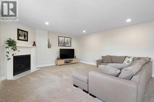 Family Room - 111 Woodside Circle Nw, Airdrie, AB - Indoor With Fireplace